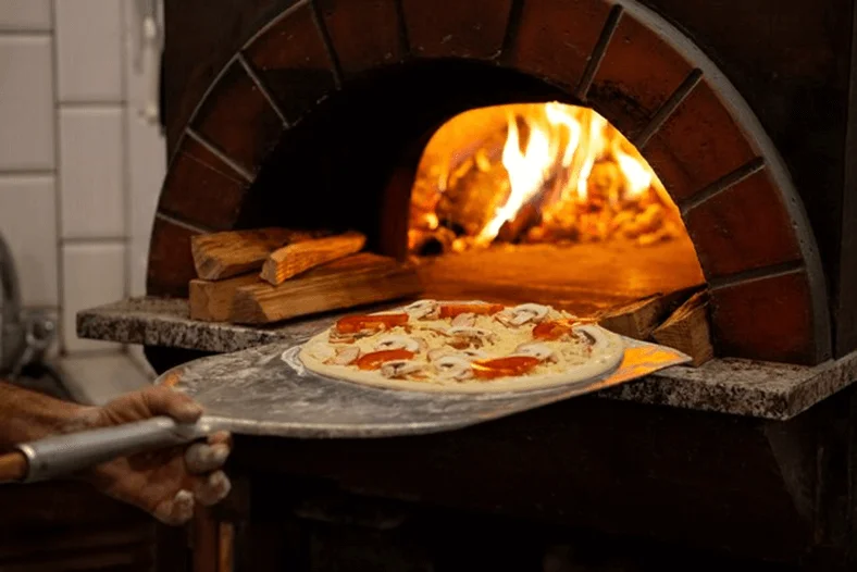How to cook pizza in a wood-fired oven
