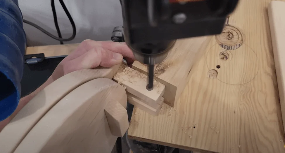 Drilling a hole through the upright pieces and the handle