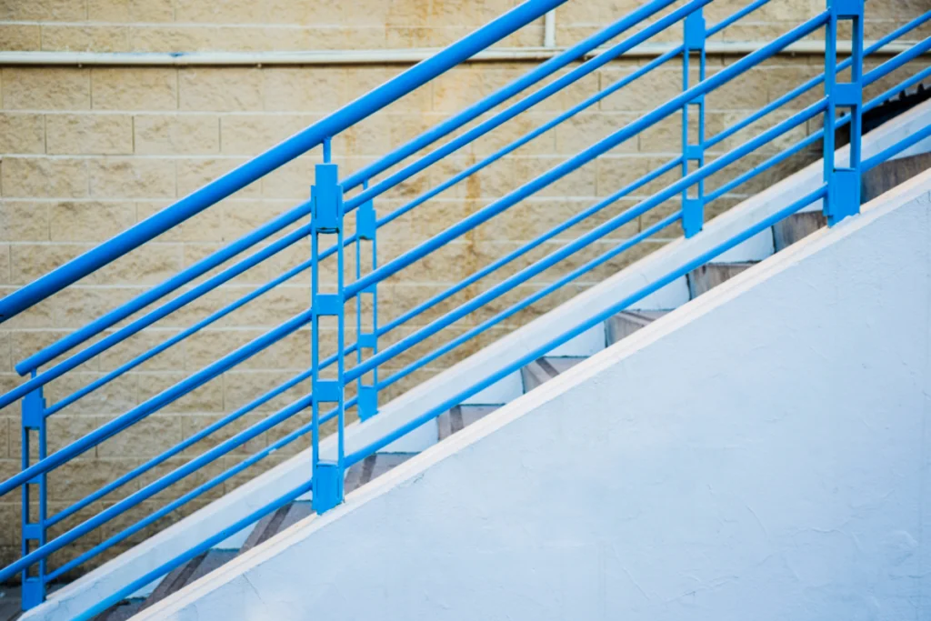 DIY blue pipe handrail on staircase