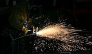 Man welding with a plasma cutter