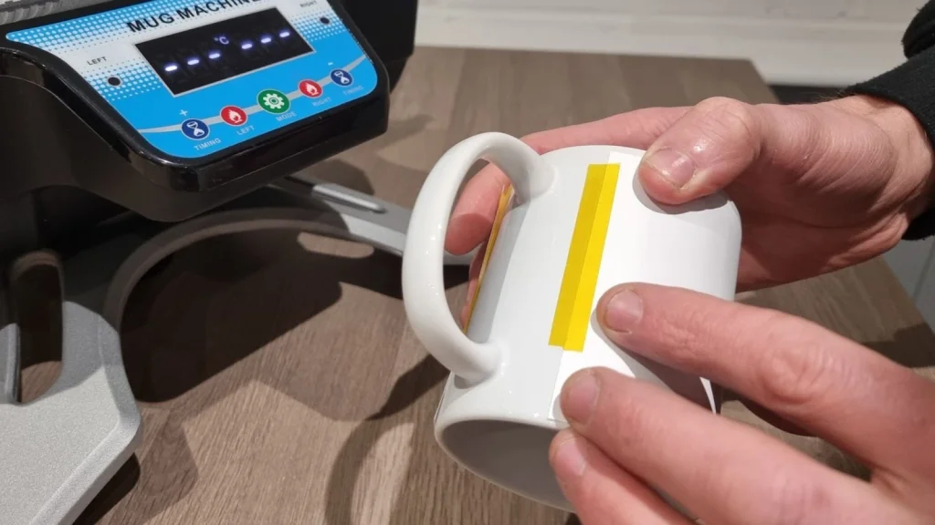 A professional using a mug heat press to customize mugs