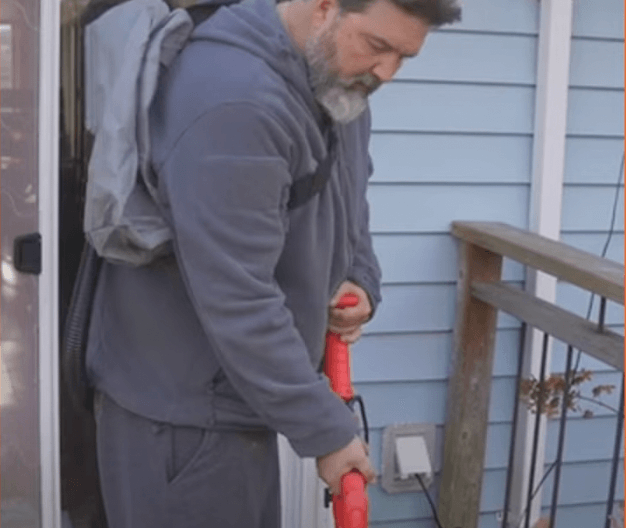 Electric drywall sander in use