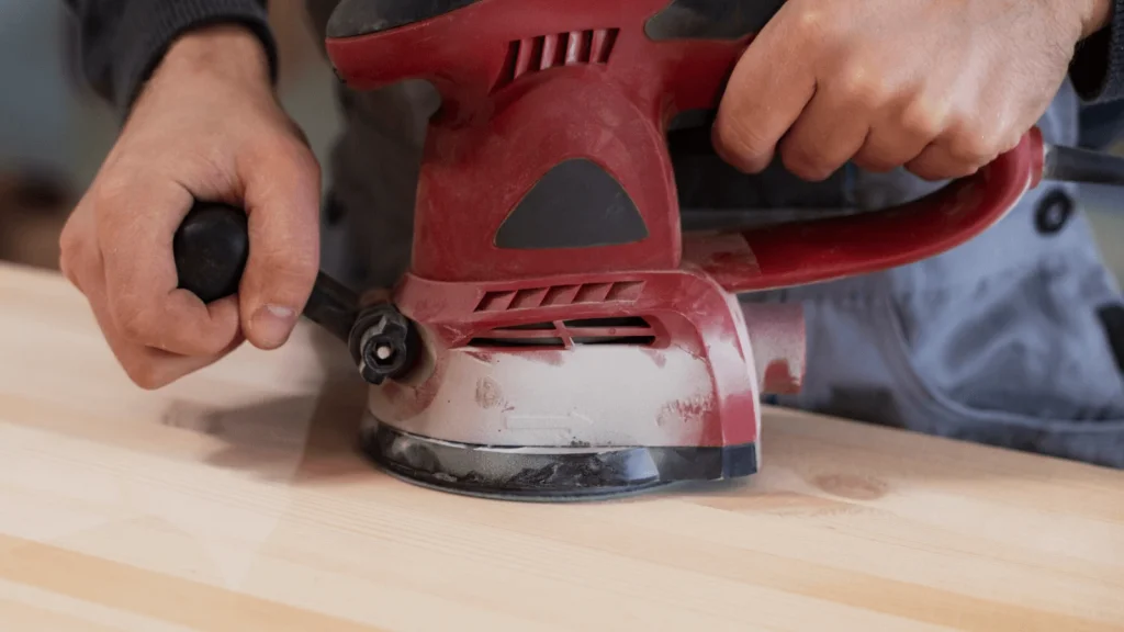 Sanding drywall with power sander