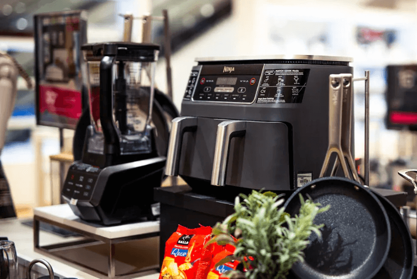An air fryer next to a blender and skillet 