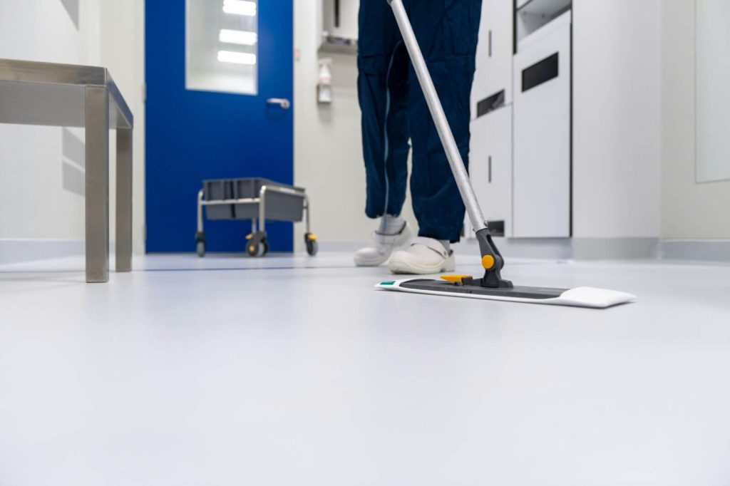 Person cleaning floor with a floor mop