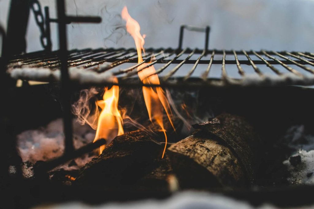 Burning Under Black Metal Grill.