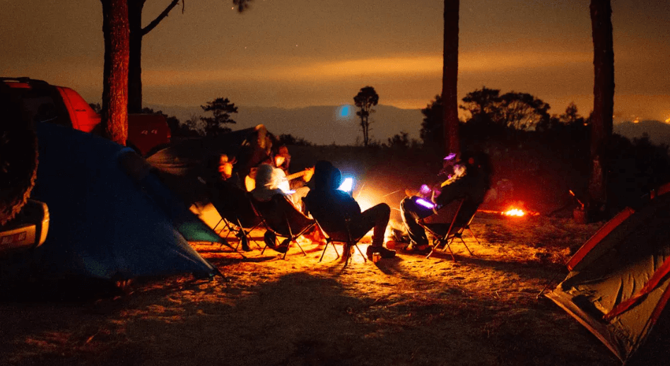 People sitting around a fire in the woods